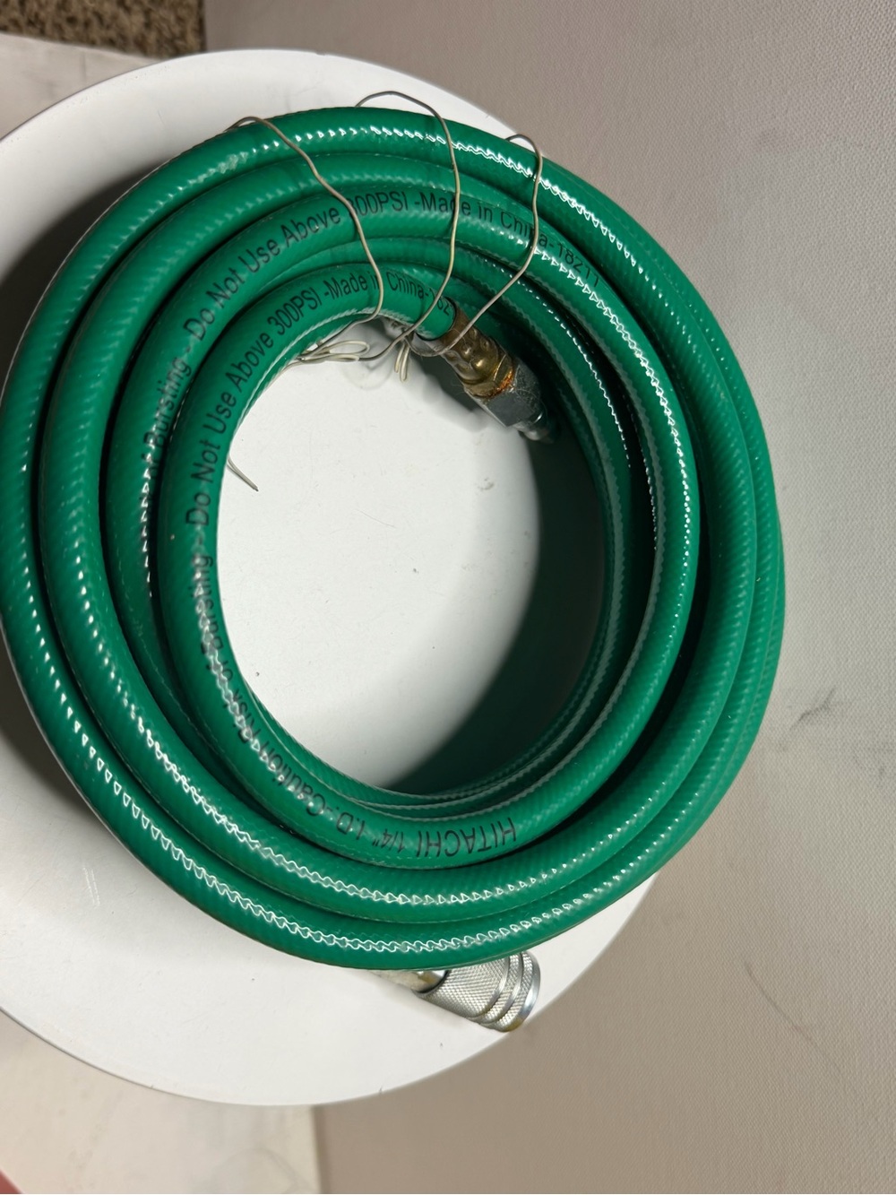 green pneumatic hose (air hose) with a 1/4-inch diameter from Hitachi